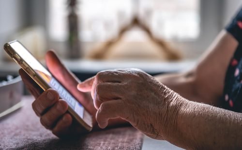 hands-elderly-woman-holding-mobile-phone