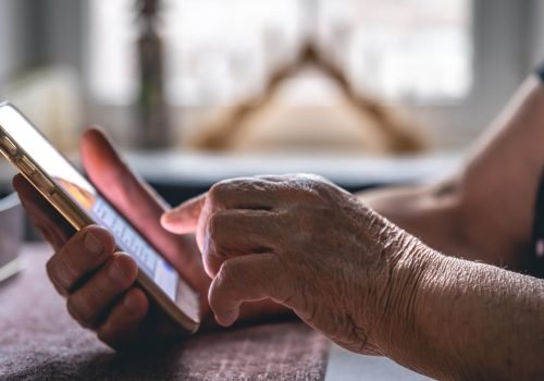 hands-elderly-woman-holding-mobile-phone