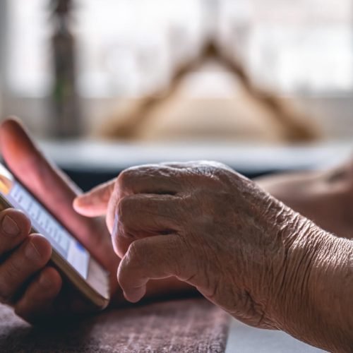 hands-elderly-woman-holding-mobile-phone
