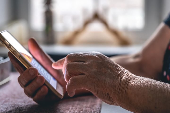hands-elderly-woman-holding-mobile-phone