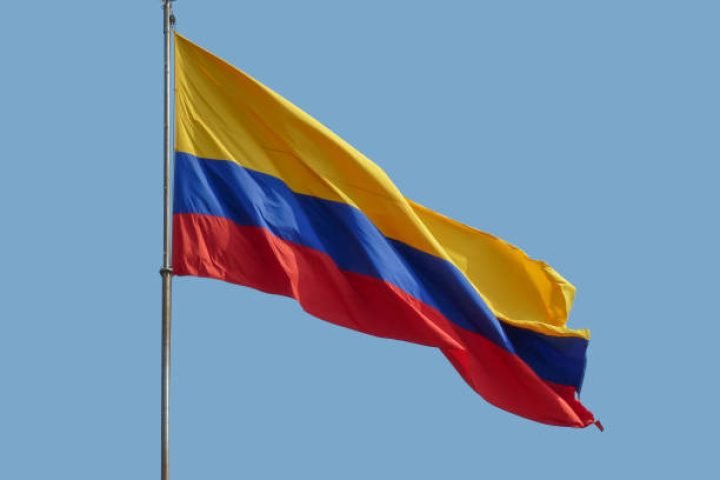 the colombian national flag in front of blue sky